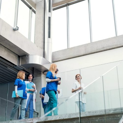 group-of-doctors-walking-in-corridor-on-medical-co-2024-10-21-05-17-41-utc-w1080-h1920 A group of young doctors walking together