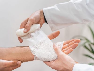 Medical bandage on patient hand in clinic.