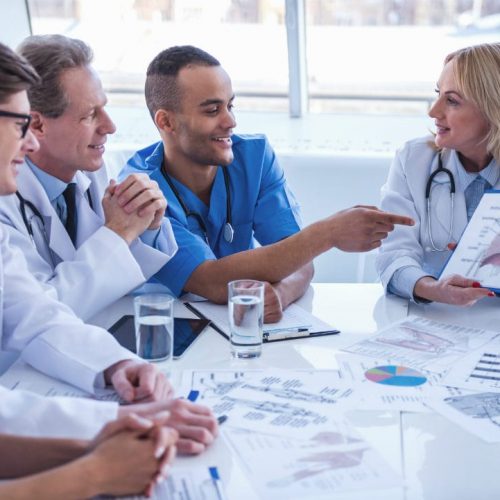medical-doctors-at-the-conference-2024-10-18-08-54-37-utc-w1080-h1920 Doctors looking at a diagram